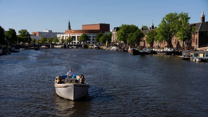 Amsterdam: Canal Cruise in Open Boat with Drink Option - Open boat comfort in sun, wind, and cold