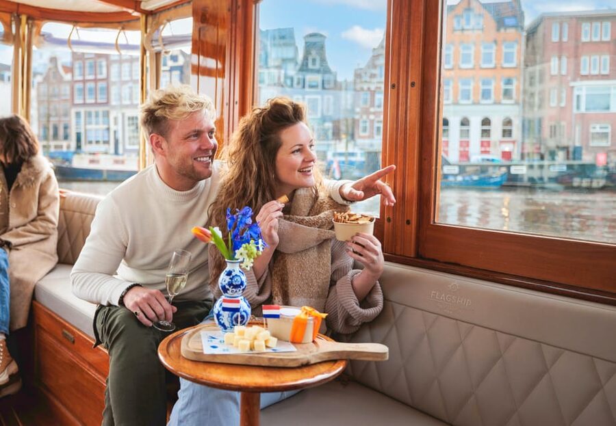 Amsterdam: Canal Cruise with Bubbles & Bites - Boarding a covered boat with bubbles and bites