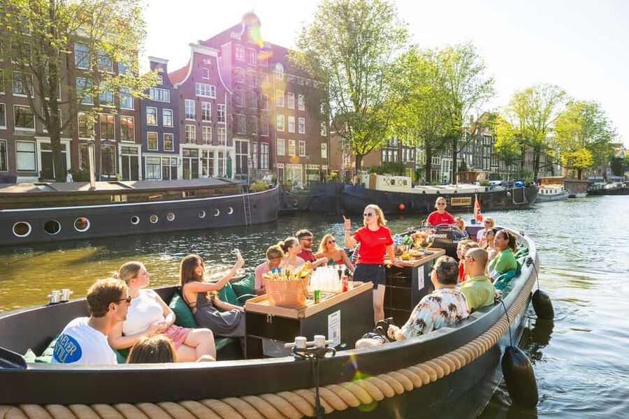 Amsterdam: Guided Open Boat Canal Cruise Including Drink - The first look: Central Station, the harbor edge, and Sea Palace