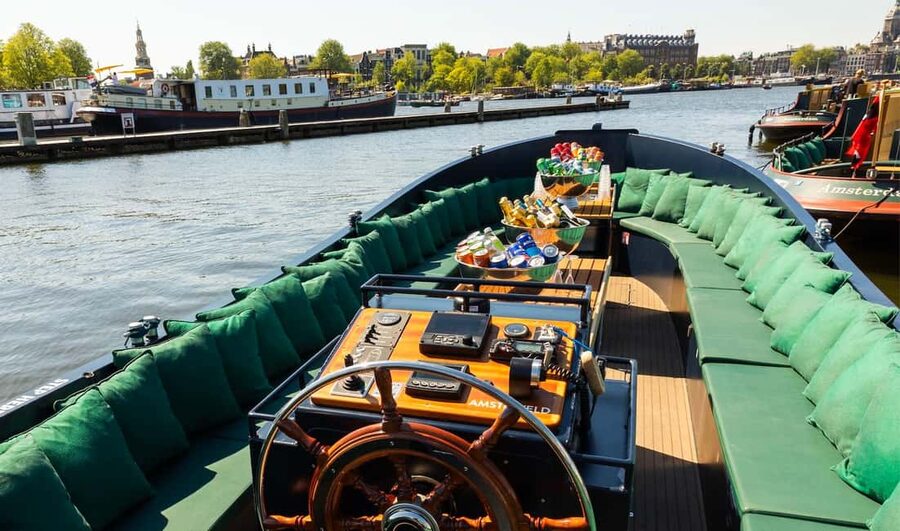 Amsterdam: Guided Open Boat Canal Cruise Including Drink - Old towers, narrow waterways, and the Jewish Cultural District
