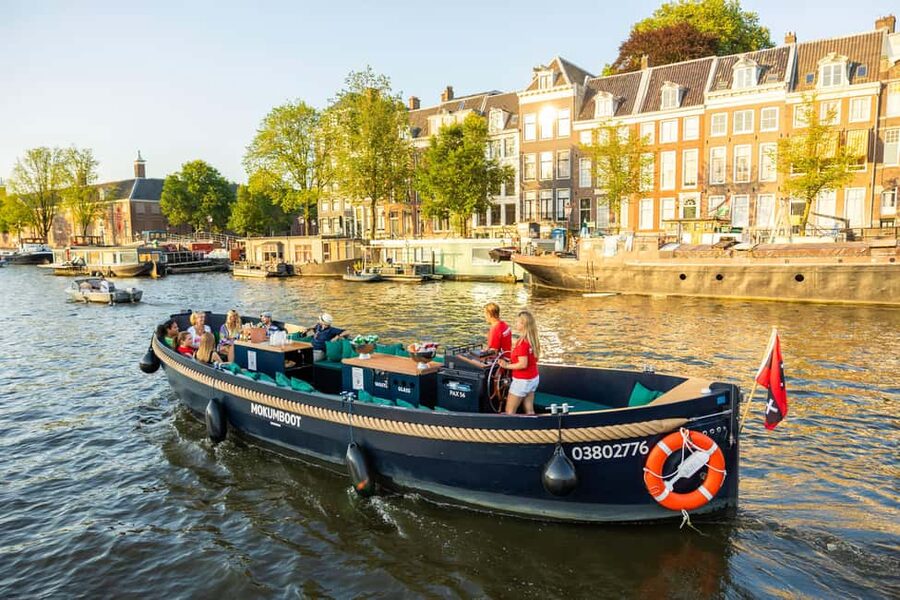 Amsterdam: Guided Open Boat Canal Cruise Including Drink - Toward the Nine Streets and the western canal ring