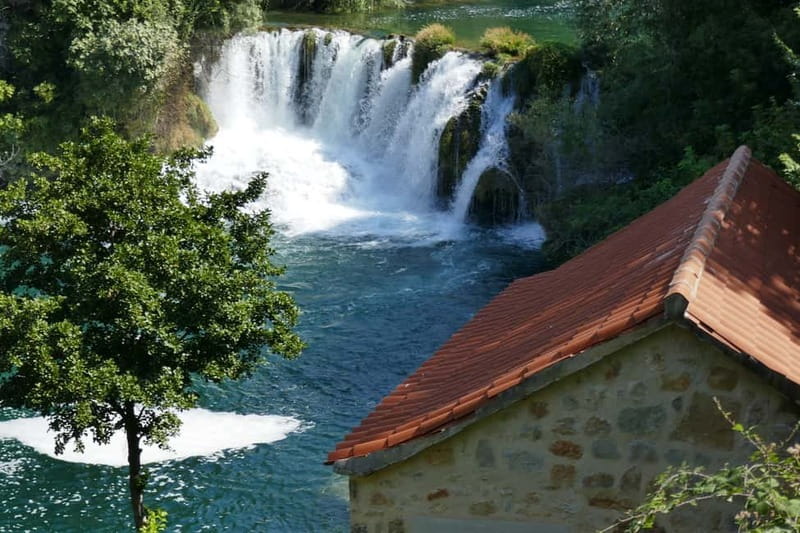 From Split: Krka Waterfalls with Riverboat Ride & swimm stop - Arriving through Krka National Park