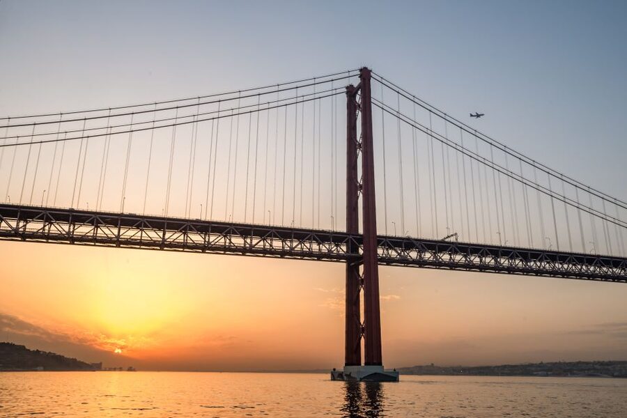 Lisbon: Private Sunset Cruise on the Tagus River with Drink - Under the 25 de Abril Bridge toward central Lisbon