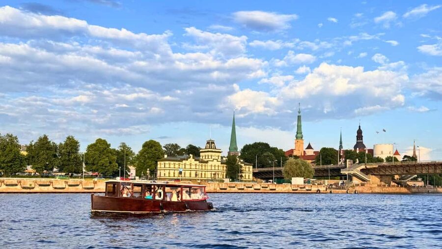 Riga: Canal Boat Tour with Welcome Drink & Audio Guide - The 100-year-old boat and the welcome drink